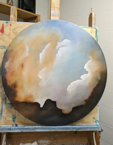 round painting of cloudy sky