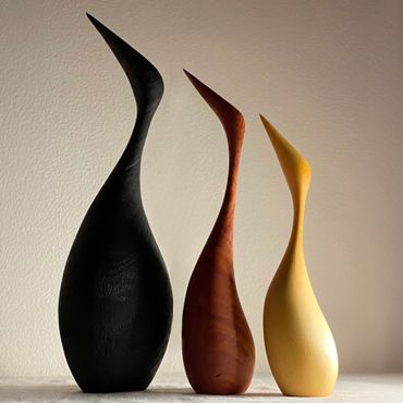 three wood sculptures of birds by Leanne Koppen