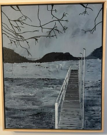 Black and white painting of a dock leading to water with boats and hills.