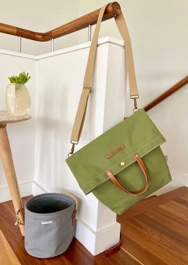 green canvas bag hanging on a stairwell