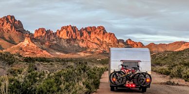 Vintage camper on dirt road in Arizona mountain desert. 