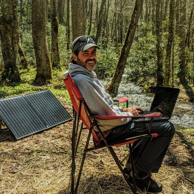 Hutch working from the road, taking advantage of solar panel power and the open air.  