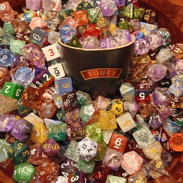 Large bowl of dice with a ceramic cup of dice in the center