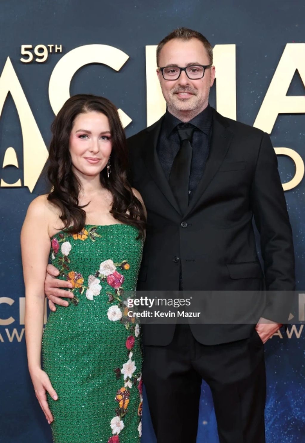 Couple posing at the 59th ACM Awards red carpet event.
