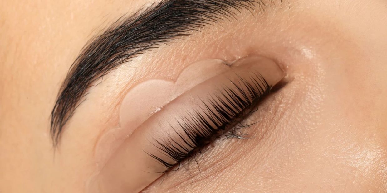 Close-up of an eye with a heart-shaped eyelid tape.