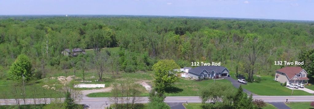 Aerial view of two houses labeled 112 Two Rod and 132 Two Rod surrounded by greenery.