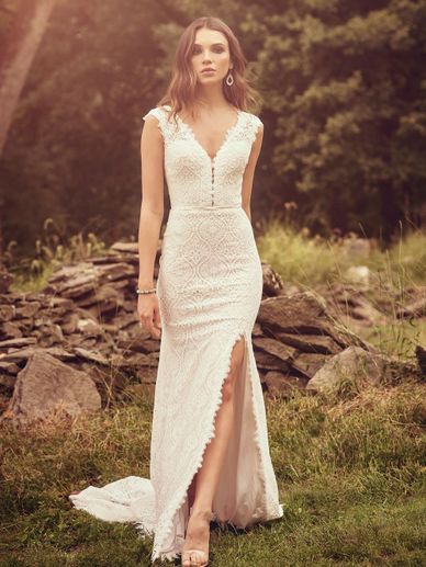 Lillian West gown made of soft lace and a thigh high slit in front.