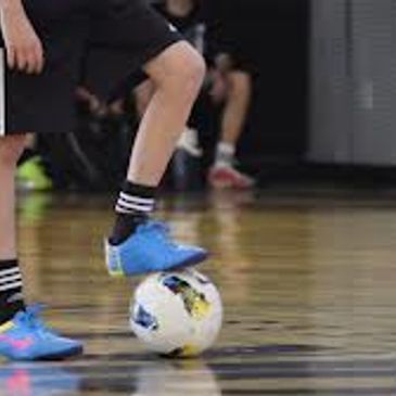 players foot on a futsal ball 