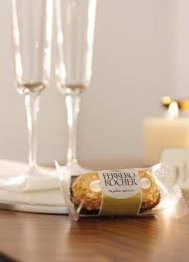 Ferrero Rocher chocolate with champagne glasses.