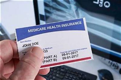 Hand holding a Medicare health insurance card.