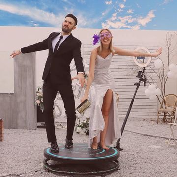 Couple standing and posing happily on a 360 degree selfie machine