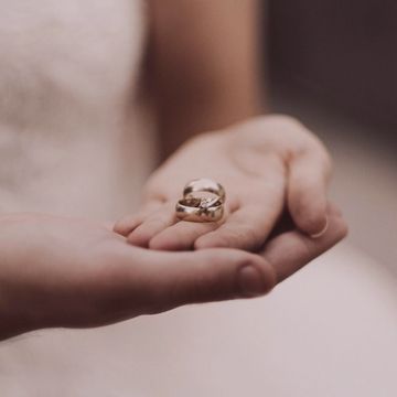 Hands holding a pair of rings