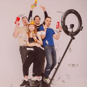 Four people standing on selfie machine with props