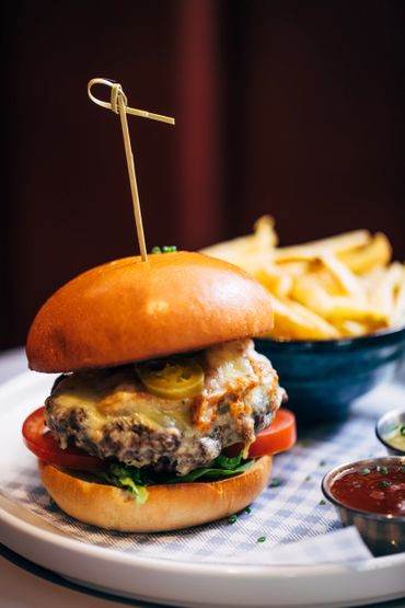 Plated burger with beef patty, cheese and fries