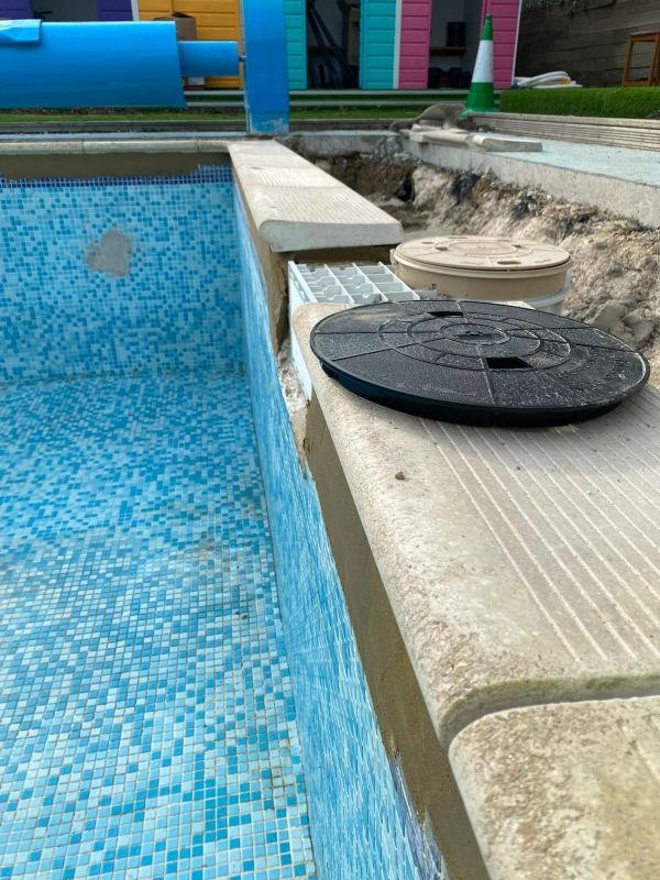 Empty tiled pool under maintenance.