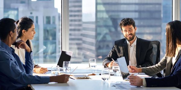 Business team having a meeting in a modern office with city views.