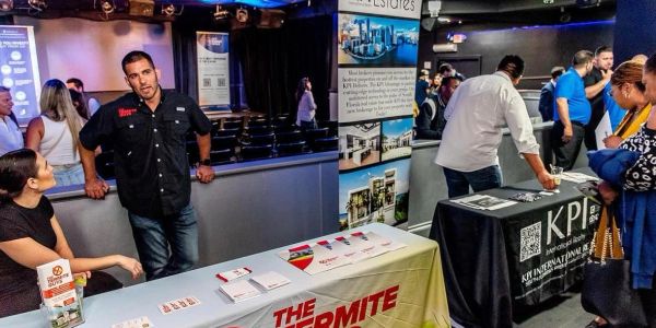 People attending a business networking event with informational booths.