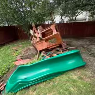 backyard playset and green slide for junk removal in San Antonio by Yellowstone Junk Removal