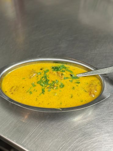 Spicy chicken curry and basmati rice with fresh cilantro garnish.

