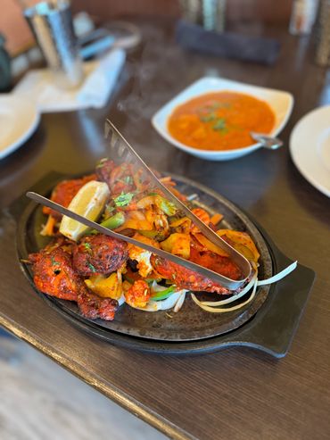 Vibrant Indian curries, rice, and naan bread served in bowls

