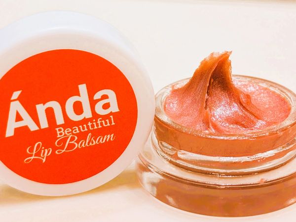 Opened jar of Anda Beautiful Lip Balsam with a creamy texture.