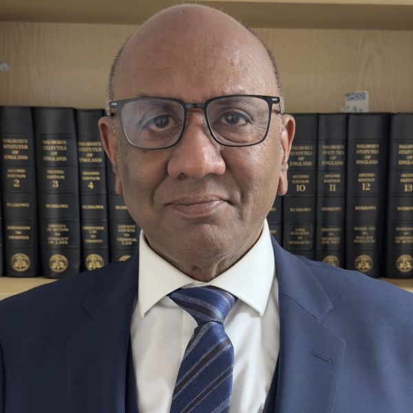 Professional man in a suit and tie with glasses.