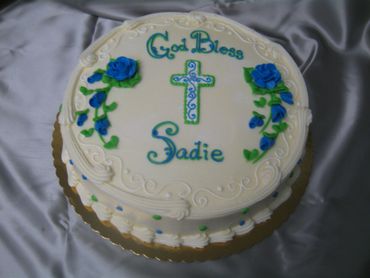 A white colored cake with blue color flowers