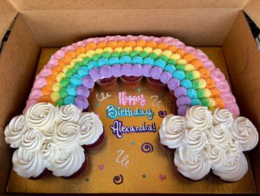Colorful rainbow cupcake arrangement with birthday message.