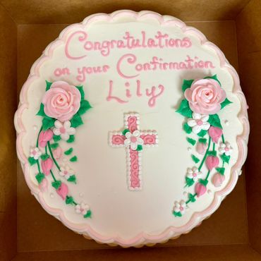 White cake with pink decorations congratulating Lily on her Confirmation.