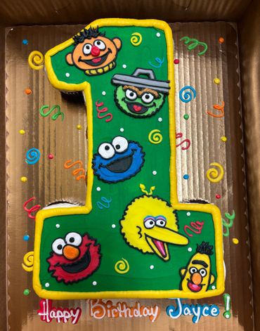 Colorful number one birthday cake with Sesame Street characters for Jayce.