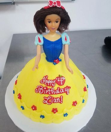 A yellow colored doll cake to Zian 