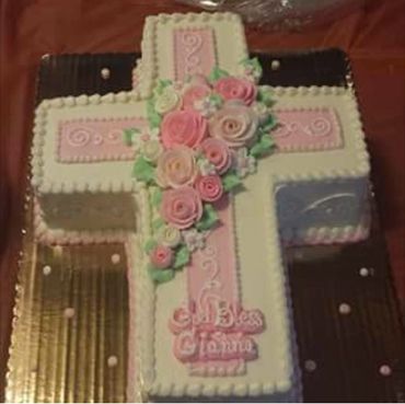 A cross symbol cake in white and pink color 