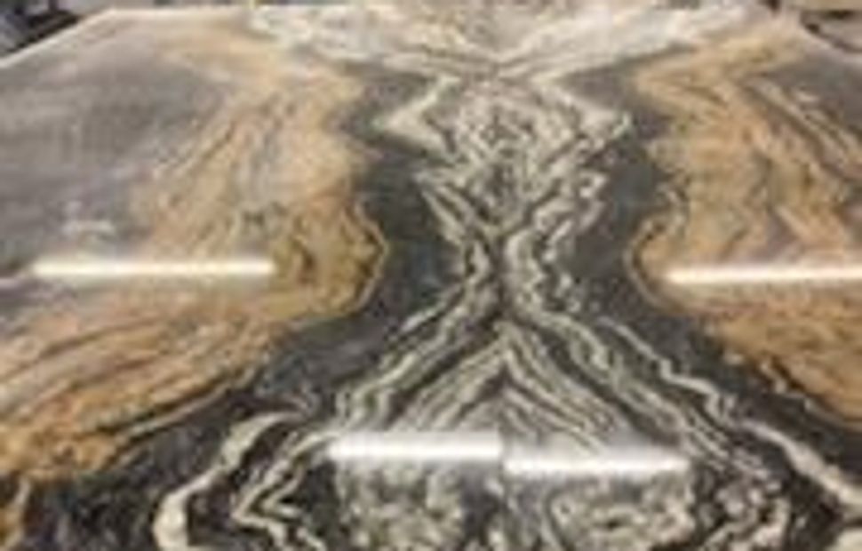 A marble slab with some brown and black colors