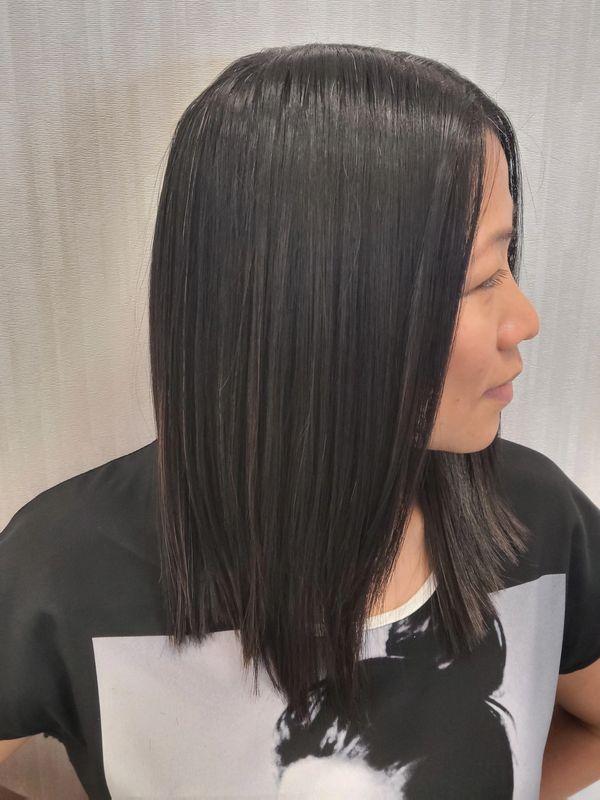 Asian woman with keratin treatment looks off camera in Peachtree City