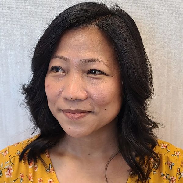 asian woman with fresh blow out from Peachtree City salon looks off camera