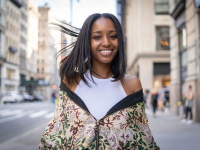 smiling girl with silk press, hair is blowing in the breeze