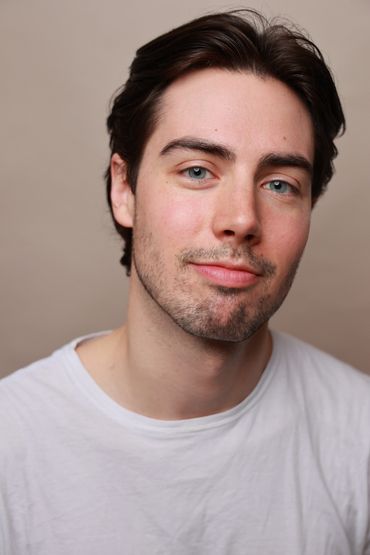 Young man with blue eyes and short dark hair.