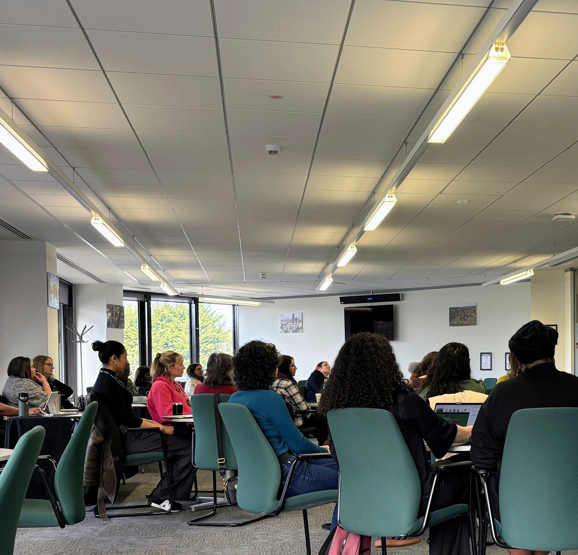 People attending a seminar or meeting in a conference room.
