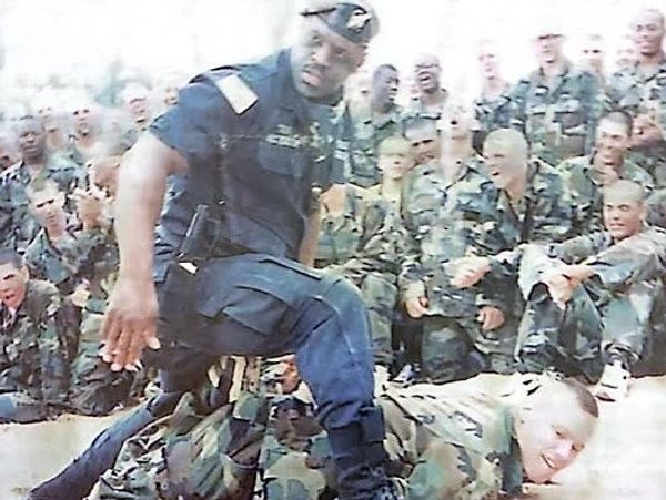 Military personnel demonstrating a physical training exercise.