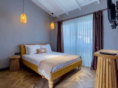 Cozy bedroom with wooden furniture and soft lighting.