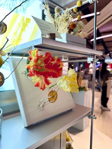 Decorative dried flowers display on a shelf.