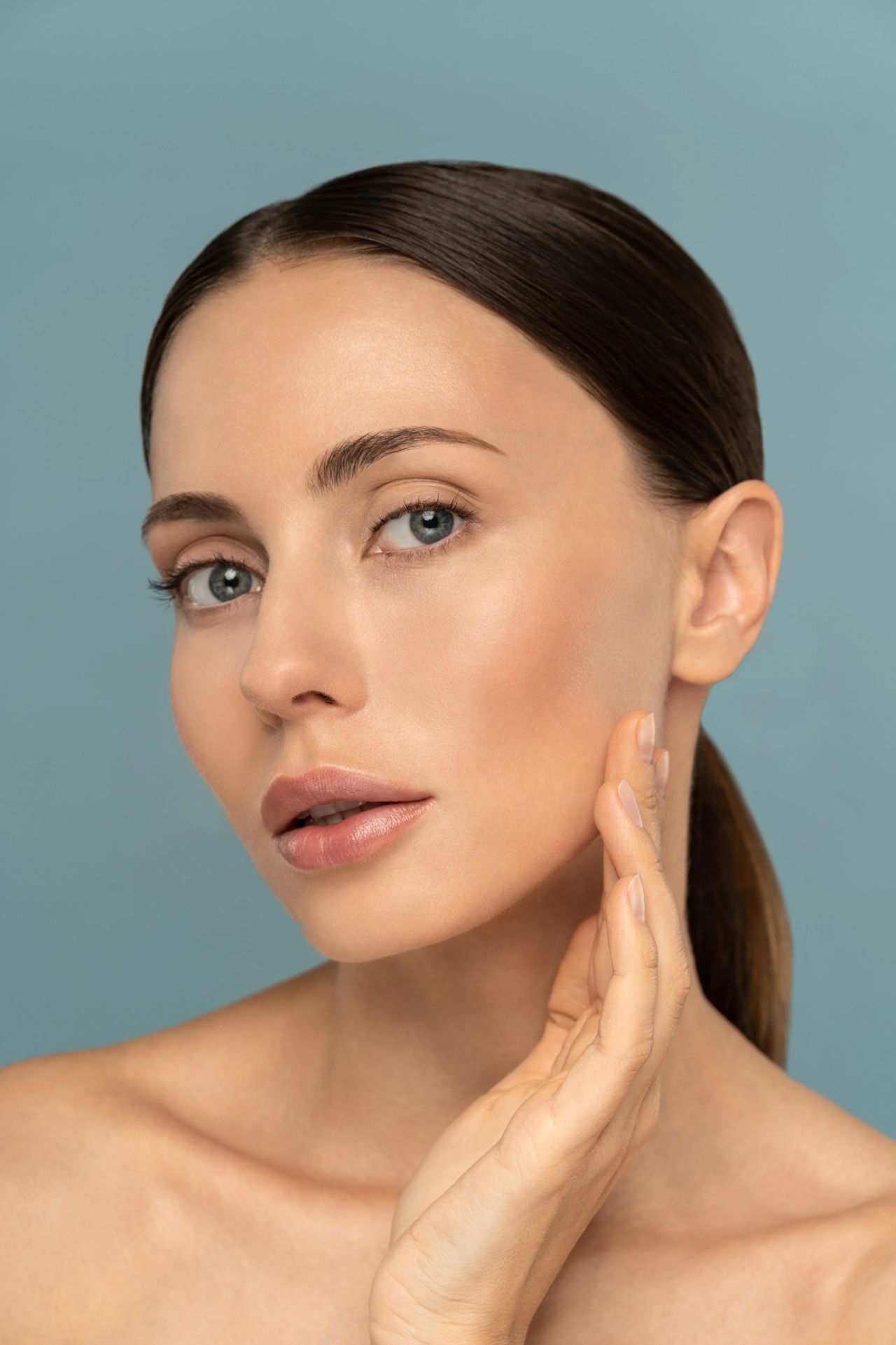 Elegant close-up of smooth, well-structured facial skin in soft light