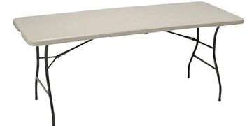 A beige folding table with black metal legs.