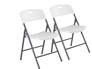 Two white folding chairs with black metal frames.