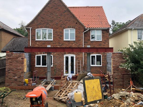 fabricated lintel being installed over opening for bifold doors