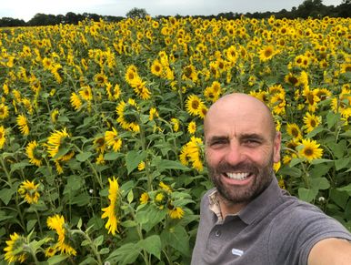 Paul Dovey in a field of sunflowers