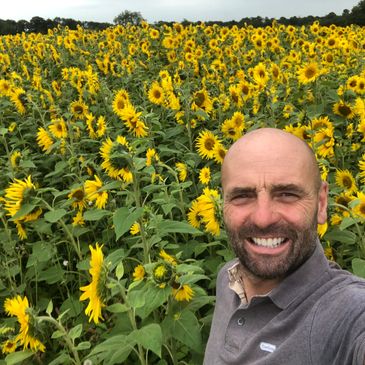 Paul Dovey in a field of sunflowers