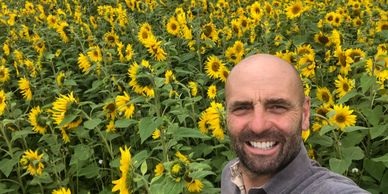 Paul Dovey in field of sunflowers