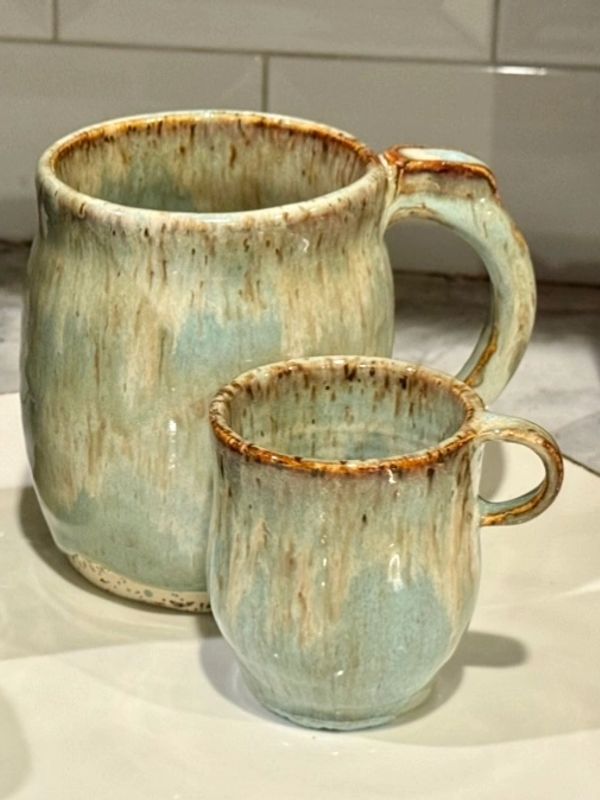 Two ceramic mugs with a rustic glaze finish.