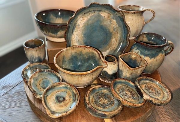 Handmade ceramic dishware set with blue and brown glaze.